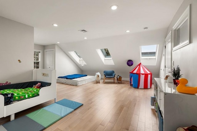 game room featuring a skylight, wood finished floors, and recessed lighting