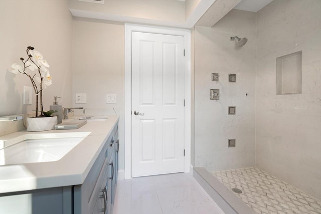 full bath featuring a shower stall, marble finish flooring, and double vanity