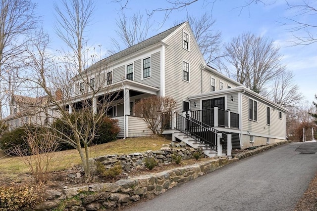 view of side of home with stairs