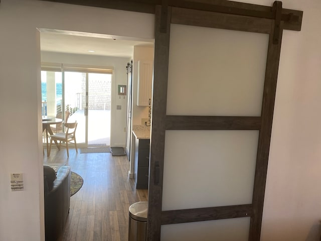 hallway with dark wood-type flooring and a water view