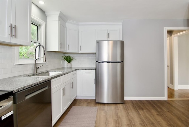63 Grandview St, Springfield, MA 01118 - kitchen with appliances with stainless steel finishes, a sink, light stone counters, white cabinets, and light wood-style floors