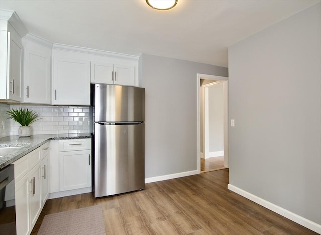 63 Grandview St, Springfield, MA 01118 - kitchen featuring freestanding refrigerator, light wood-type flooring, backsplash, and light stone countertops