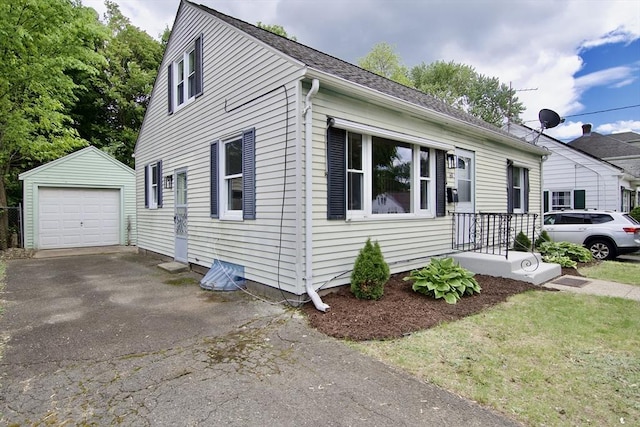 63 Grandview St, Springfield, MA 01118 - view of front facade featuring an outdoor structure, asphalt driveway, and a detached garage