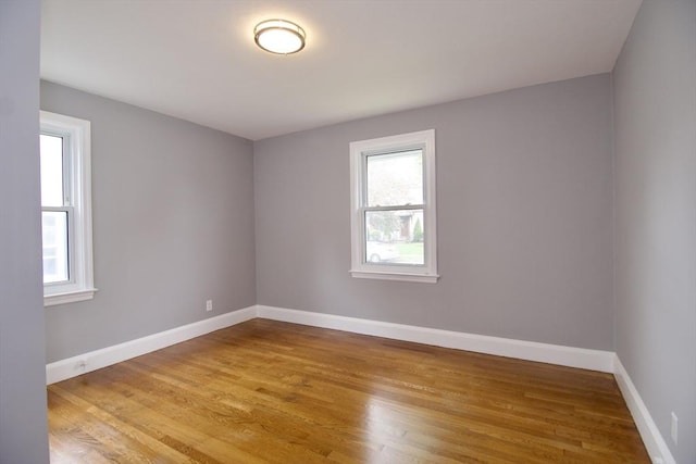 63 Grandview St, Springfield, MA 01118 - empty room with healthy amount of natural light, wood finished floors, and baseboards