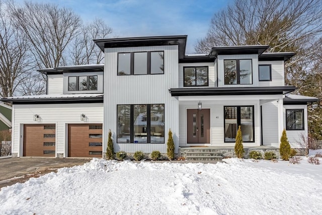 modern home featuring a garage and a porch