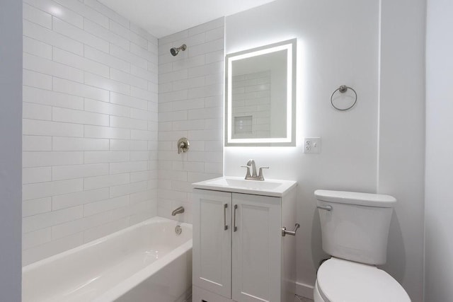 full bathroom featuring vanity, tiled shower / bath, and toilet