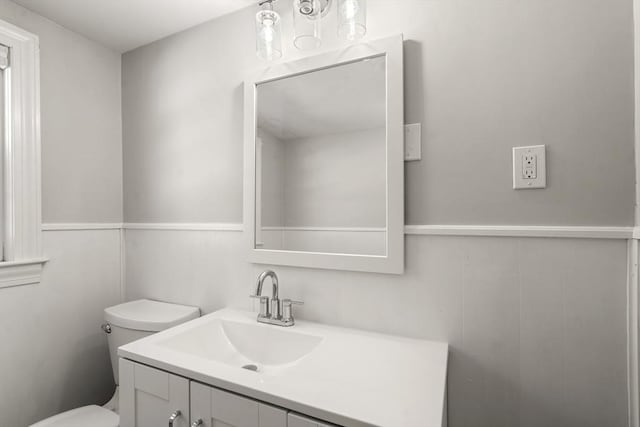 bathroom with toilet and vanity