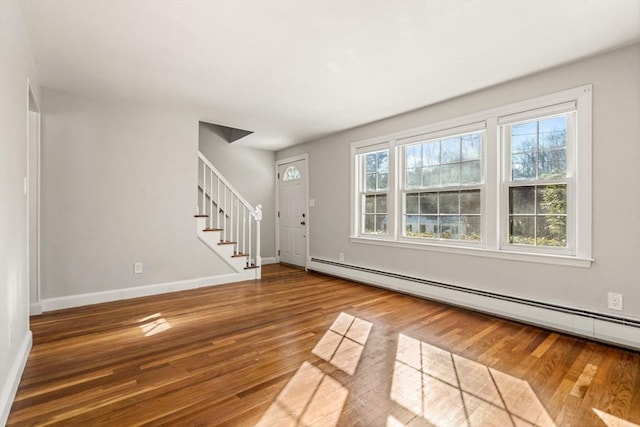 entryway featuring wood-type flooring and a baseboard radiator