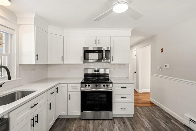 kitchen featuring sink, stainless steel appliances, and white cabinets