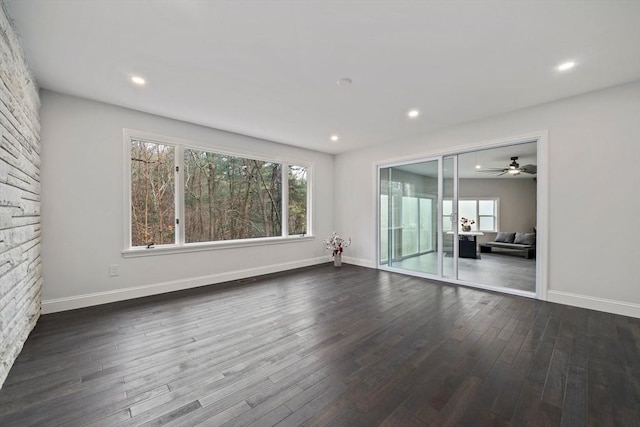 unfurnished room featuring dark hardwood / wood-style floors and ceiling fan