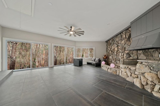 unfurnished sunroom featuring ceiling fan