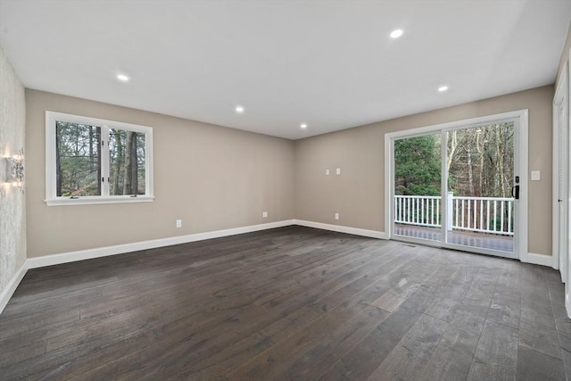 spare room with dark hardwood / wood-style floors