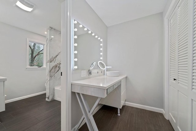 bathroom featuring hardwood / wood-style floors, vanity, and a shower