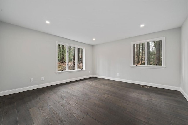 spare room featuring dark wood-type flooring