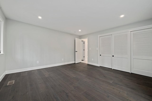 unfurnished bedroom featuring dark hardwood / wood-style floors