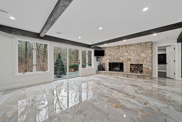 unfurnished living room featuring beamed ceiling and a fireplace