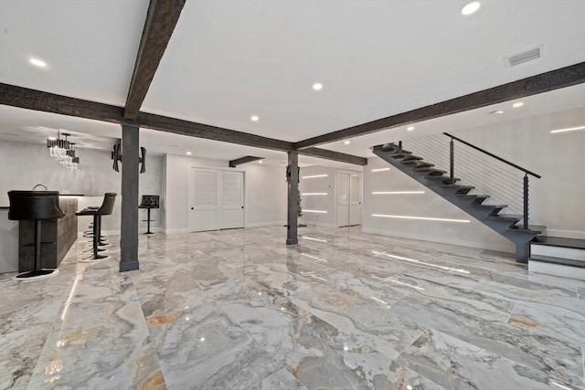 unfurnished living room with beam ceiling