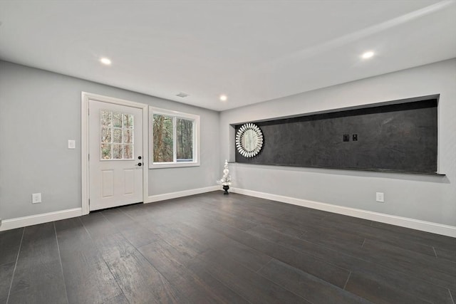 unfurnished room featuring dark hardwood / wood-style flooring