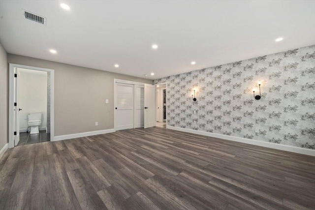 empty room with dark hardwood / wood-style flooring