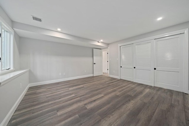 unfurnished bedroom with dark hardwood / wood-style flooring