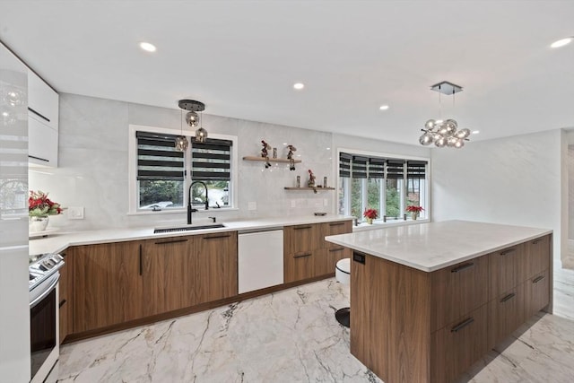 kitchen with a wealth of natural light, electric range, sink, hanging light fixtures, and white dishwasher