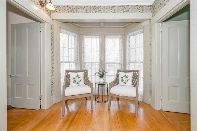 sitting room with a healthy amount of sunlight and hardwood / wood-style floors