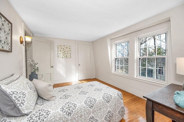 bedroom featuring baseboards and light wood-style floors