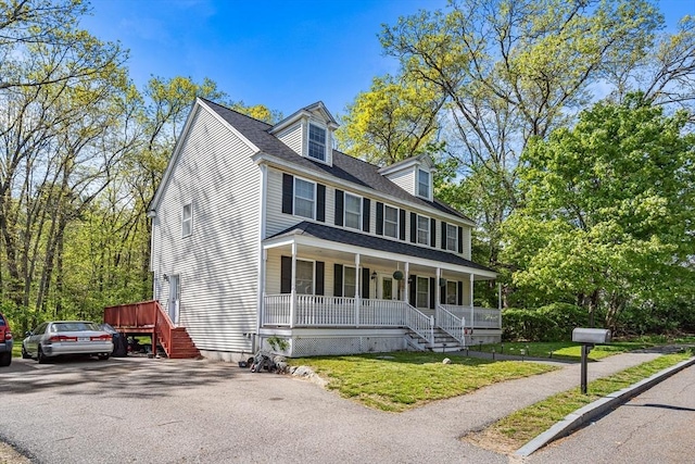 view of front of property with covered porch and a front yard