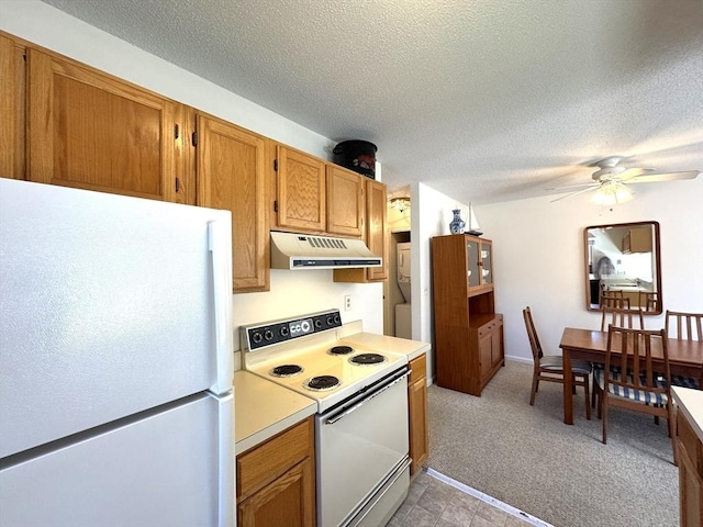 kitchen with light carpet, a ceiling fan, under cabinet range hood, white appliances, and light countertops