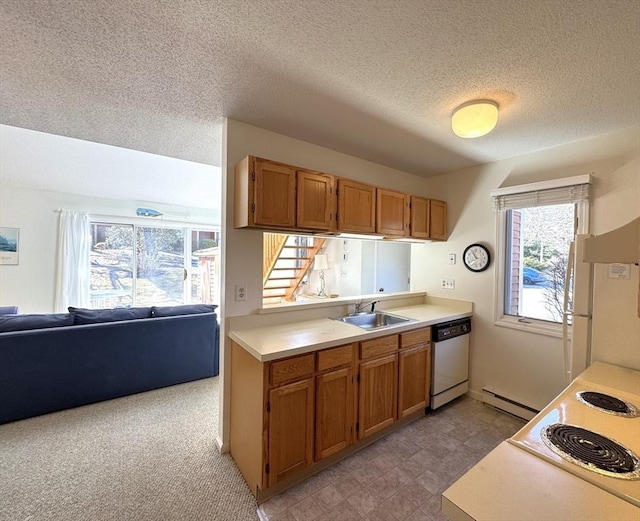 kitchen featuring a baseboard heating unit, dishwasher, light countertops, brown cabinets, and a sink