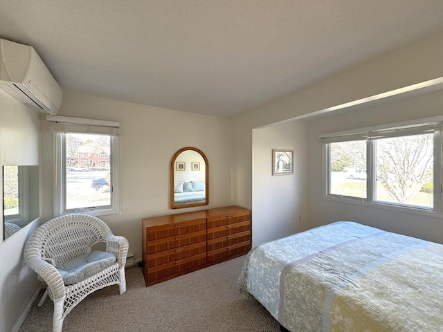 bedroom with an AC wall unit and carpet floors