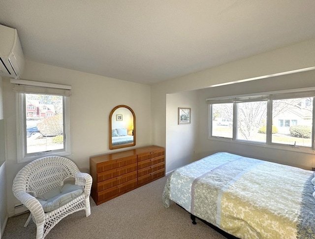 carpeted bedroom featuring a wall mounted AC