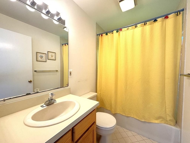 bathroom featuring tile patterned floors, toilet, vanity, and shower / tub combo