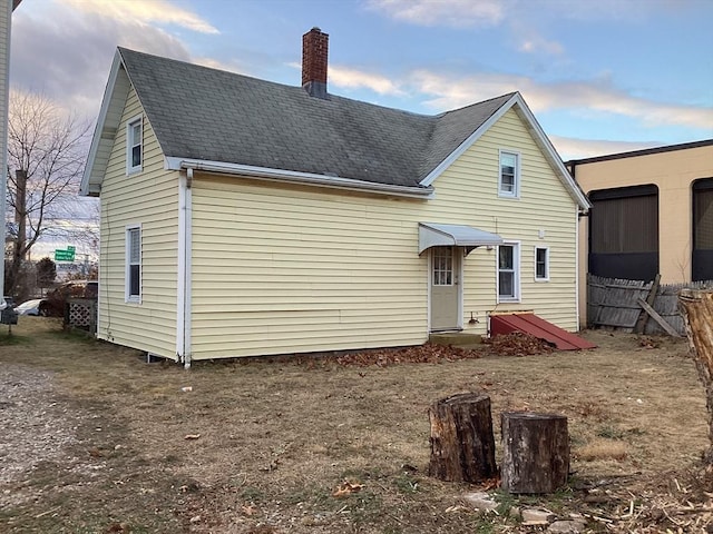 view of back house at dusk