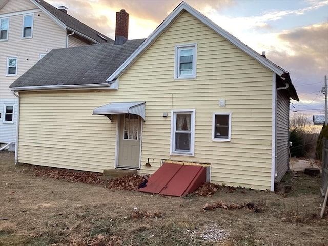 view of back house at dusk