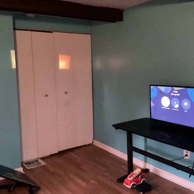 interior space with hardwood / wood-style floors and beamed ceiling