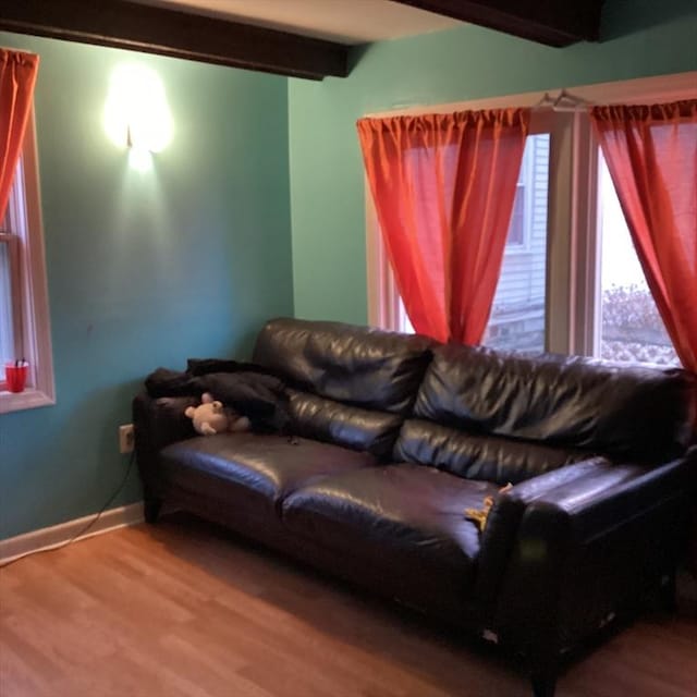 living room with beamed ceiling and wood-type flooring