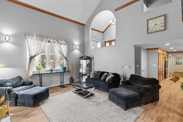 living area featuring high vaulted ceiling, ornamental molding, wood finished floors, recessed lighting, and arched walkways