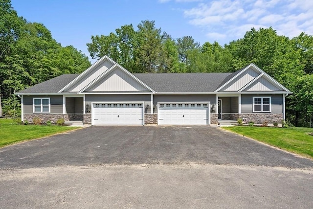 craftsman house featuring a garage and a front yard