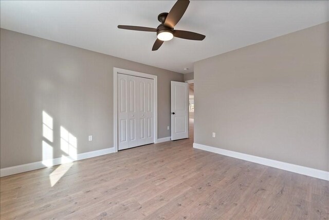 empty room featuring ceiling fan and light wood-type flooring