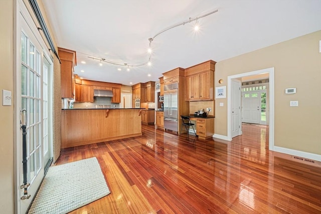 6 Northey Farm Rd, Scituate, MA 02066 - kitchen featuring built in fridge, exhaust hood, a peninsula, dark countertops, and light wood-style floors
