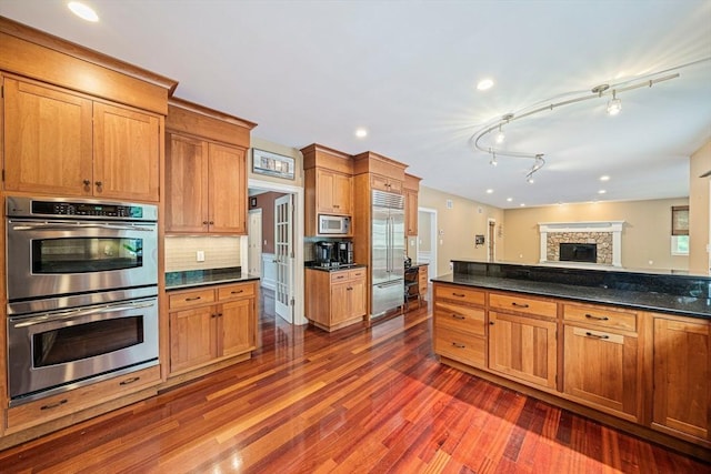 6 Northey Farm Rd, Scituate, MA 02066 - kitchen with built in appliances, dark wood finished floors, decorative backsplash, recessed lighting, and a fireplace