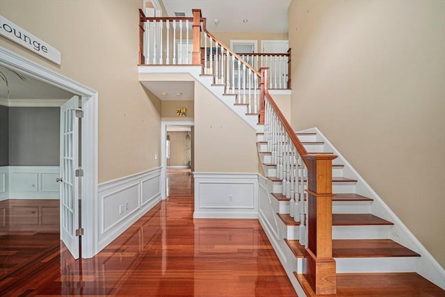 6 Northey Farm Rd, Scituate, MA 02066 - stairs featuring wood finished floors, a wainscoted wall, and a towering ceiling