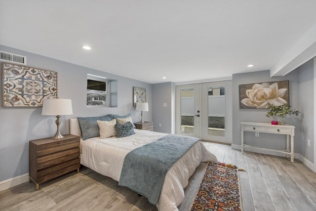 bedroom with visible vents, baseboards, light wood-style flooring, access to exterior, and french doors