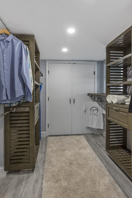 walk in closet featuring wood tiled floor