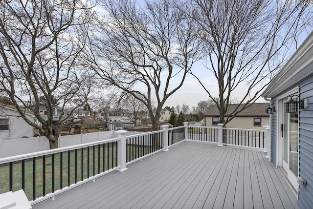 wooden deck featuring a residential view, a yard, and fence