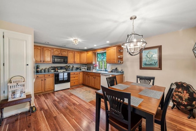 64 E Main St, Middleboro, MA 02346 - kitchen with electric stove, black microwave, a chandelier, dishwasher, and light wood finished floors