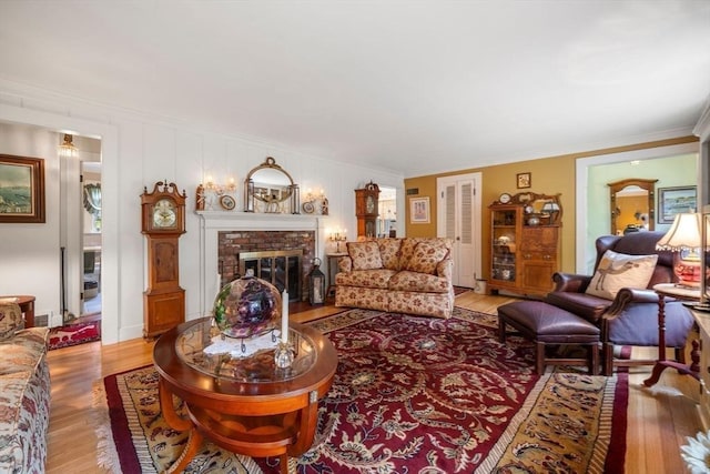 64 E Main St, Middleboro, MA 02346 - living area featuring wood finished floors, crown molding, and a fireplace