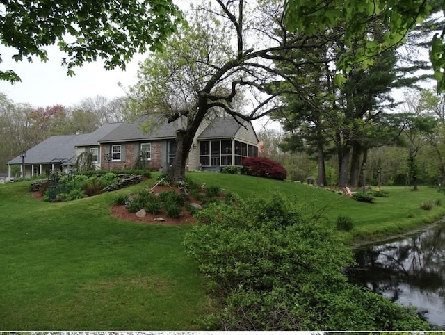 64 E Main St, Middleboro, MA 02346 - view of front of house featuring a sunroom, a front lawn, and brick siding