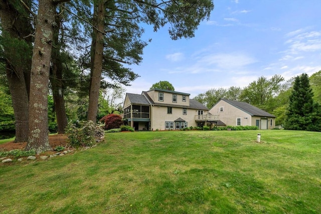 64 E Main St, Middleboro, MA 02346 - back of house with a sunroom and a lawn